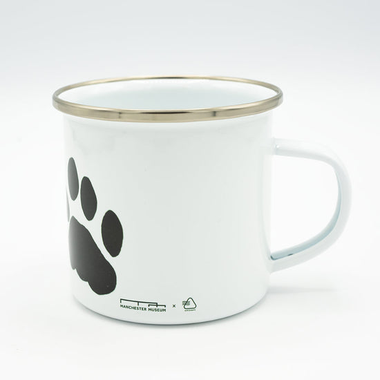 White mug with black paw print design on a white background