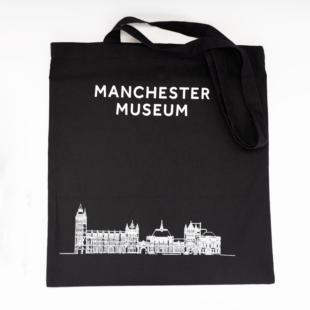 Black tote bag with Manchester Museum logo at the top and and an illustration of the building at the bottom. 