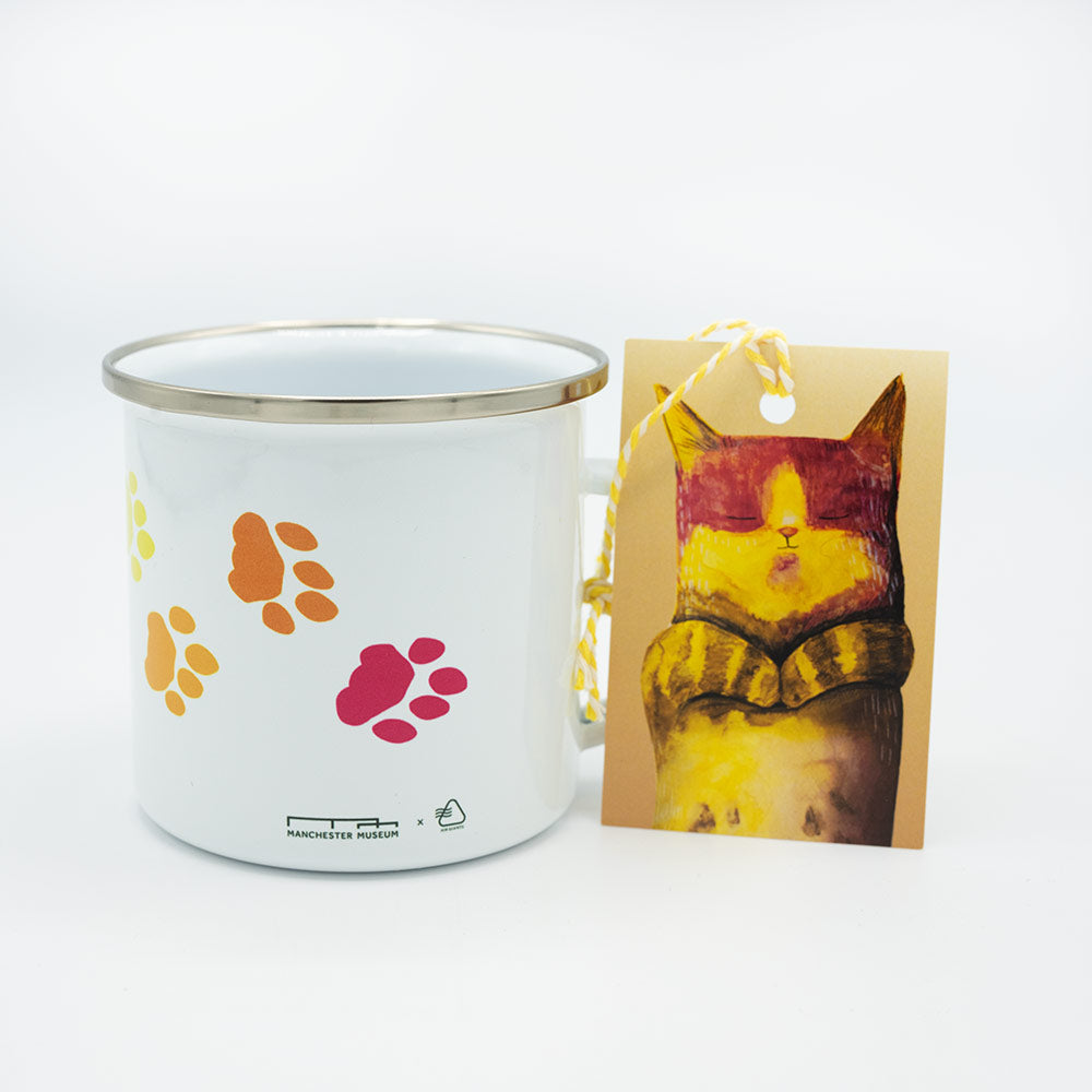 White mug with colorful paw prints and a card with a cat illustration on a white background