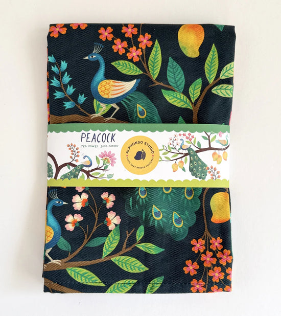Tea Towel with peacock design and 'Alphonso Studio' paper bellyband against white background.