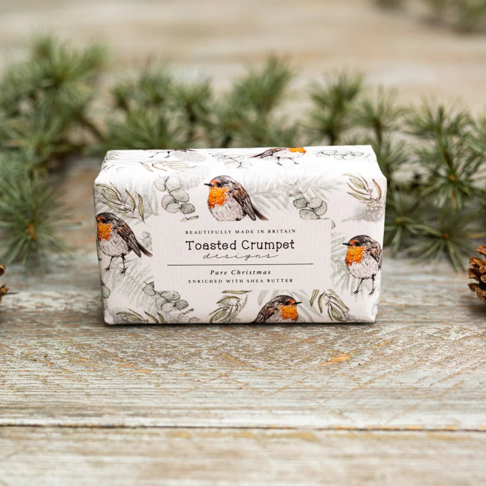 Soap bar with robin print packaging, presented on a wooden surface