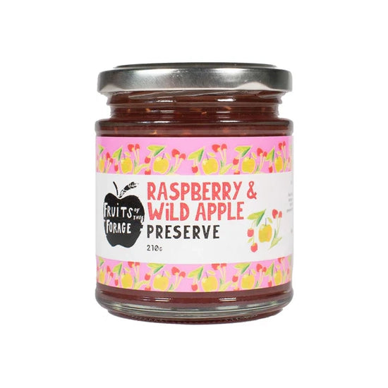 A glass jar of raspberry & wild apple preserve. The label includes the Fruits of the Forage logo and a drawing of raspberries and apples.