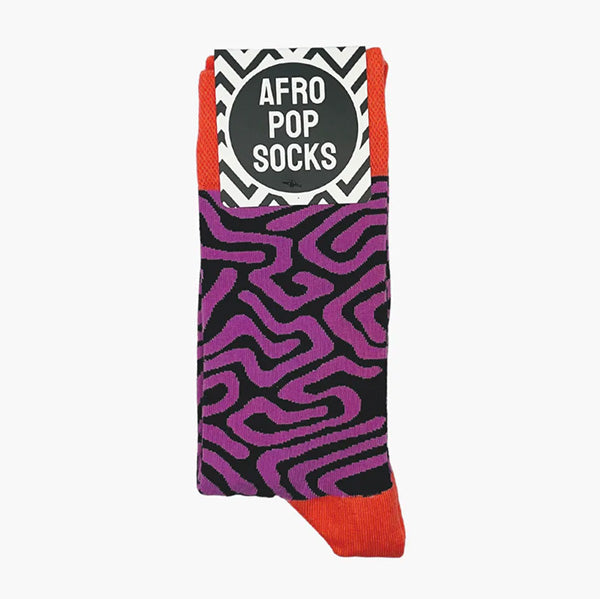 Purple, and black swirl patterned socks photographed folded with Afropops branded label. 