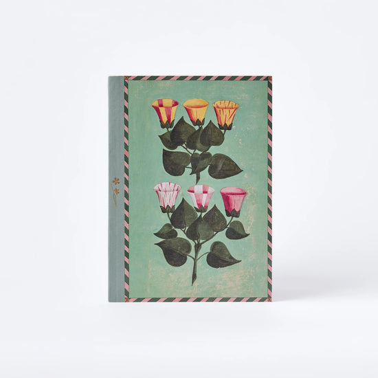 Notebook with floral design on a light green background