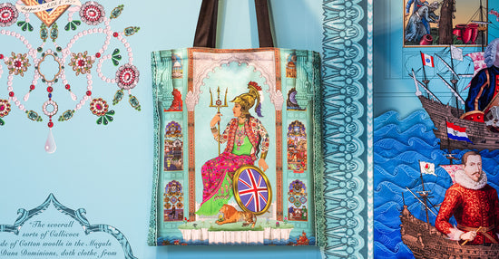 Image of a tote bag featuring an artwork by the Singh Twins hung in front of a decorated mural