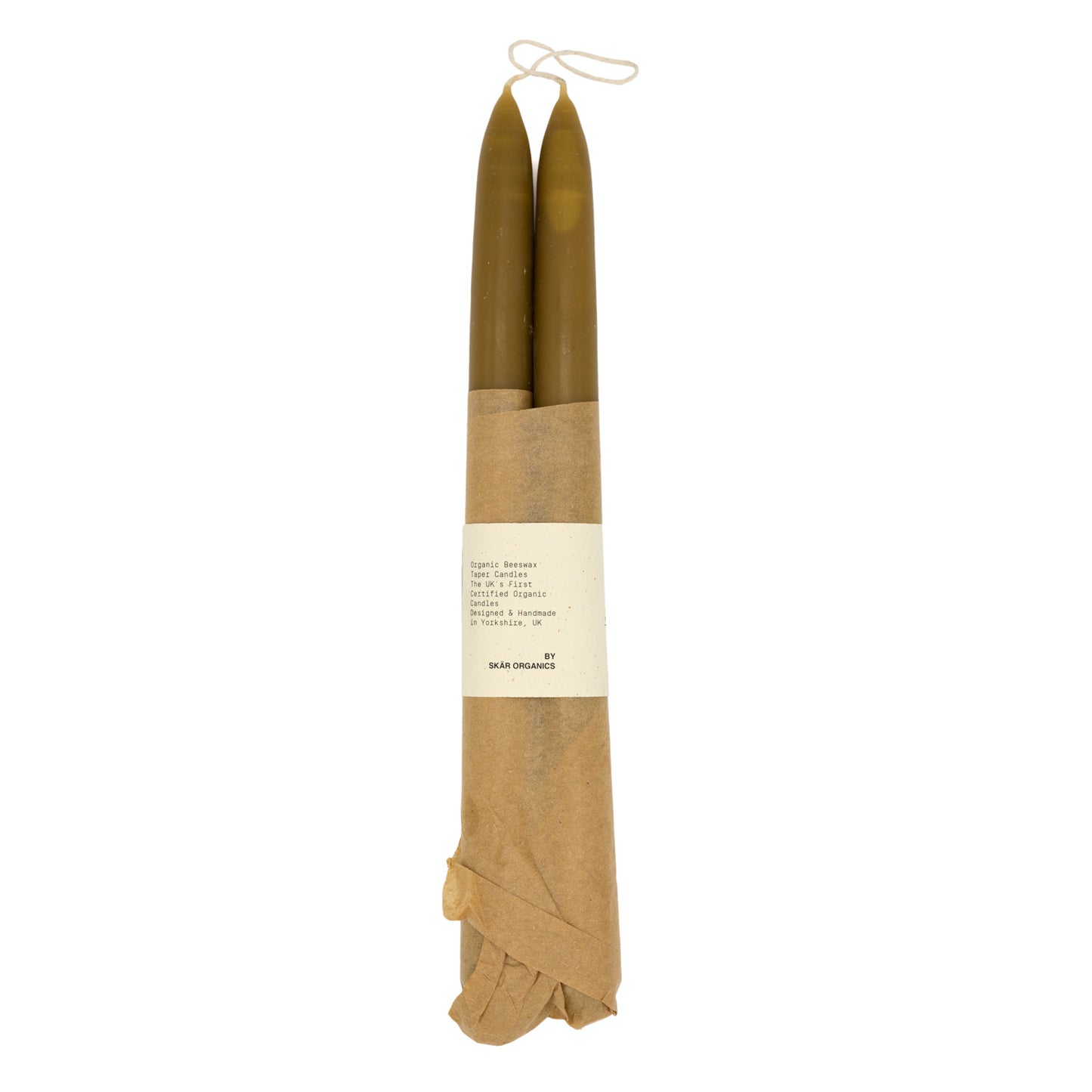 A pair of organic beeswax candles wrapped in brown paper with text that says “Skar Organics Designed & Handmade Candles”  on a white background.