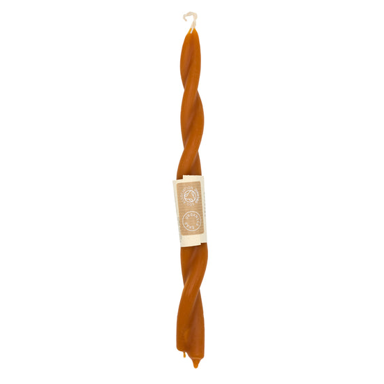 A long, orange beeswax candle with a string wrapped around its base. The candle sits on a white background.