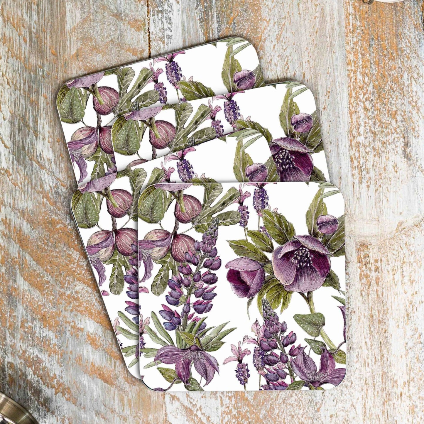 Load image into Gallery viewer, Stack of 4 coasters with purple and black floral design.  Photographed against wooden surface.
