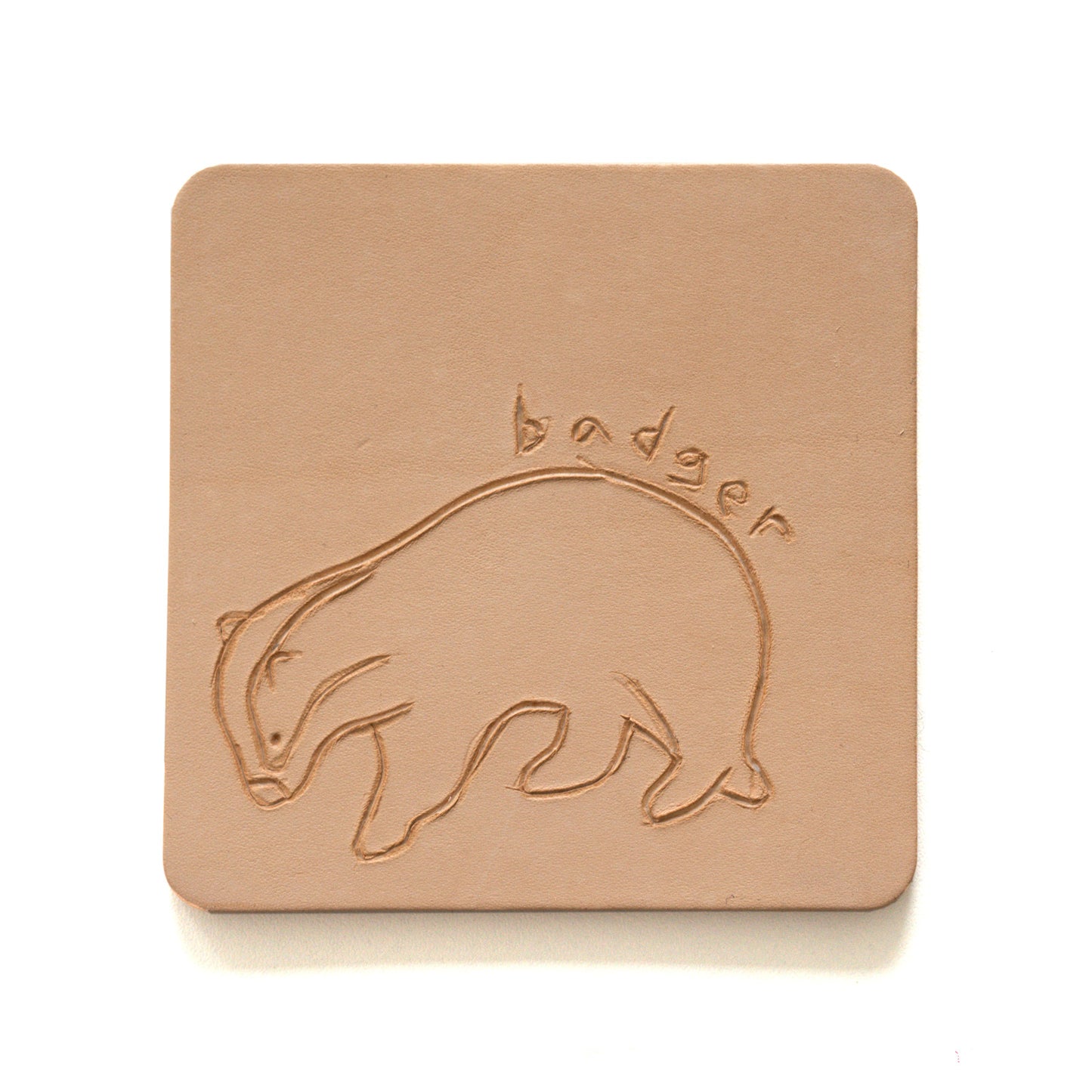 Beige leather coaster with engraving of a badger