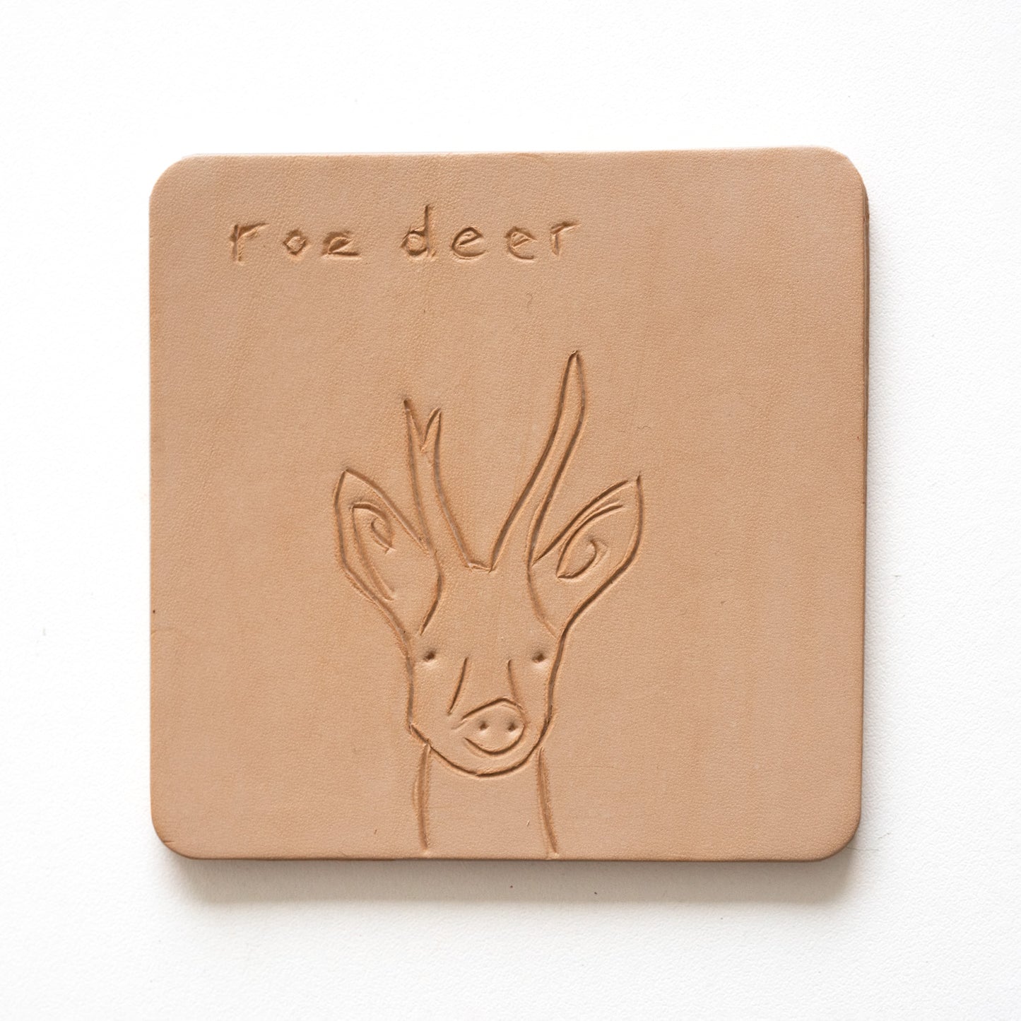 Beige leather coaster with engraving of a roe deer