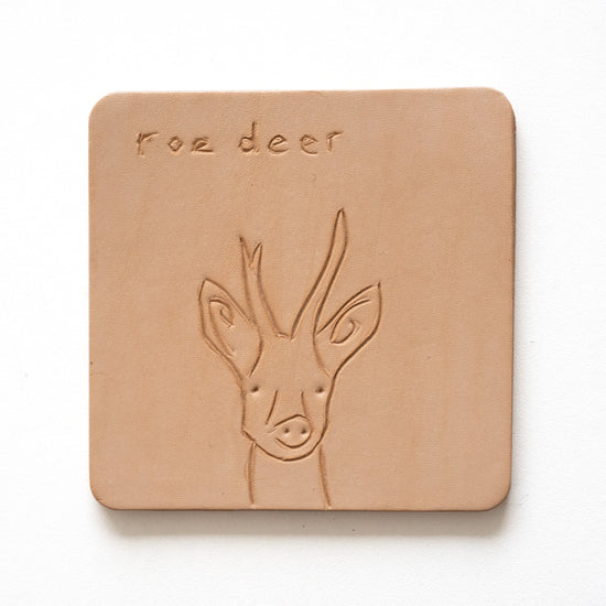 Beige leather coaster with engraving of a roe deer