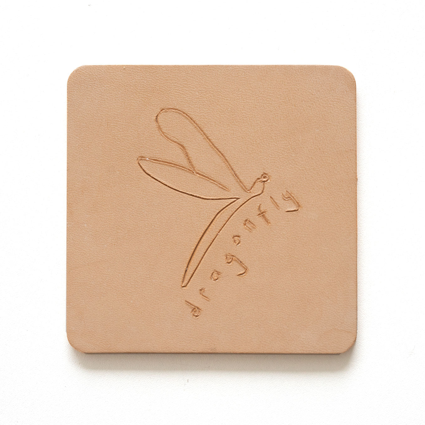 Beige leather coaster with engraving of a dragonfly