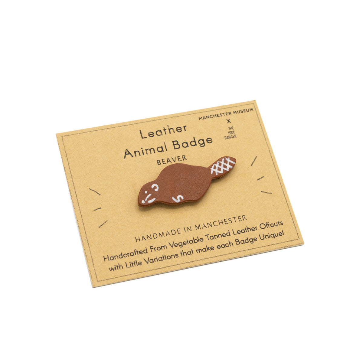 Handmade and hand painted badge in the shape of a beaver, against a brown backing card with The Hide Ranger's logo and product information.