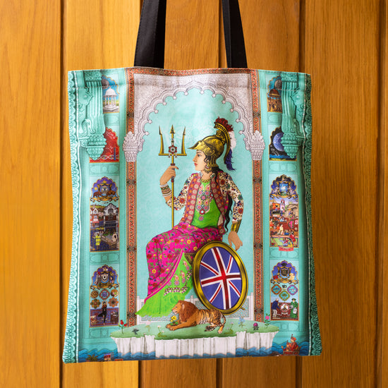 Photograph of Brit-Asia Design Tea Towel by the Singh Twins. Photographed against a brown door.