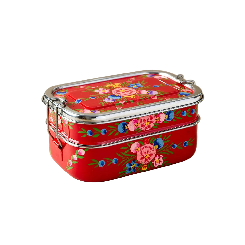 Red floral-patterned tiffin lunch box on a beige background