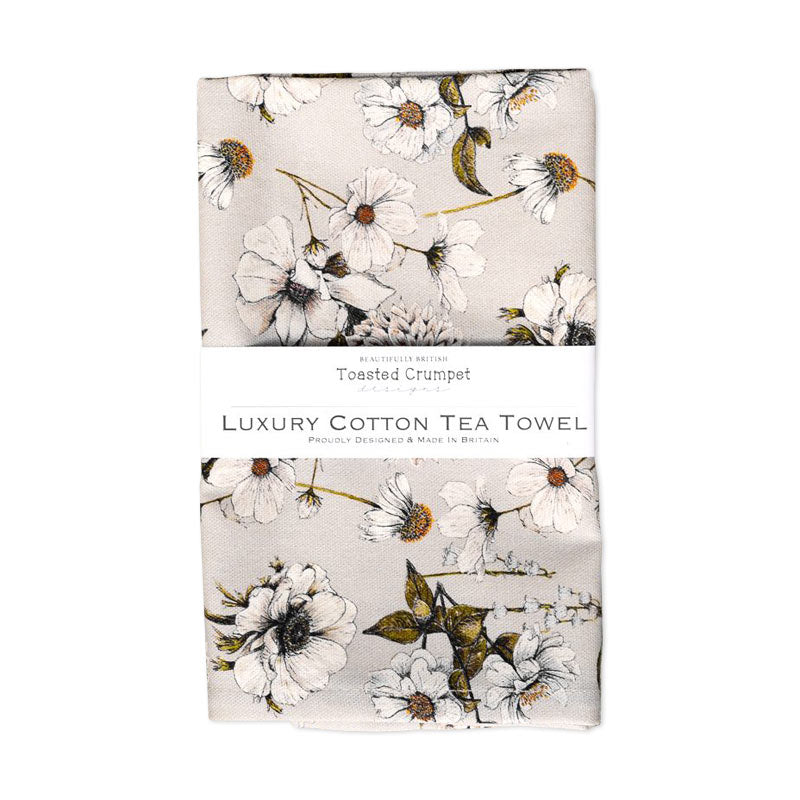 Tea towel with floral print on a light grey background