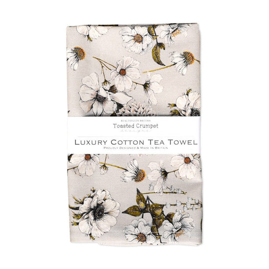 Tea towel with floral print on a light grey background