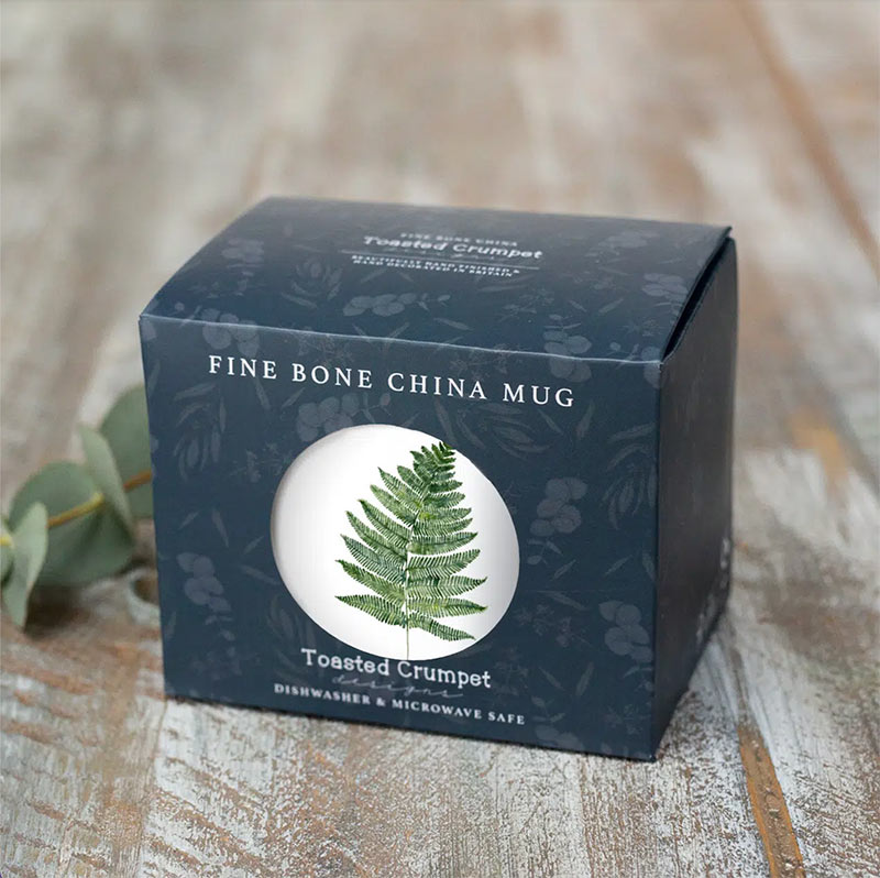 Card cube packaging - inside is White mug with a watercolour illustration of a fern leaf