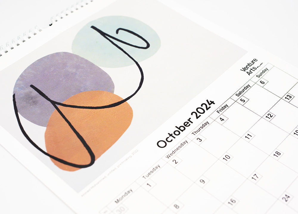 A close up of the October page of the calendar featuring an blue, orange and black abstract work.