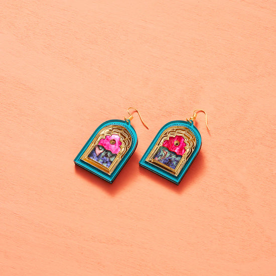 Load image into Gallery viewer, A pair of arched doorway earrings on a peach backdrop. The archways are turquoise along the edge and have a golden trim. The top arch centre is hot pink while the bottom has mixed marbling of greens and blue colours.
