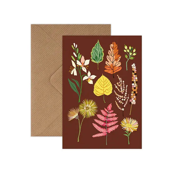 Brown greetings card with autumn plants and leaves.