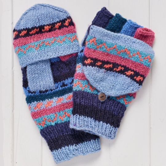 Pair of colorful knitted mittens on a white wooden surface
