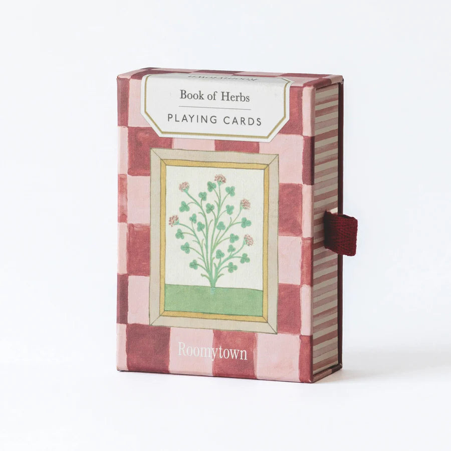 Playing cards box in light and dark pink squares with a floral illustration on the front.