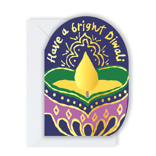 A Diwali greeting card featuring a diya (oil lamp) with a golden flame, surrounded by colourful patterns. The card has the text "Have a bright Diwali" written on it.