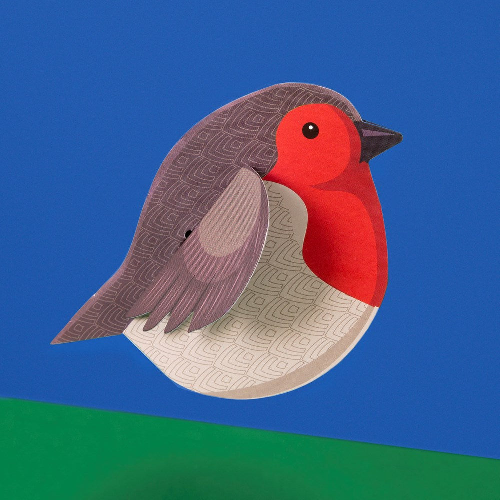 Load image into Gallery viewer, The assembled robin in a side view against a blue and green background.
