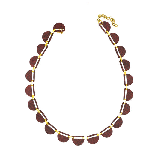 Necklace comprising of a number of burgundy semi-circles bound together with gold fastenings. Photographed birds-eye view against a white background.