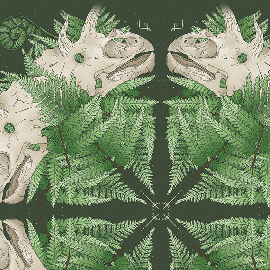 Close up of patterned artwork design with dinosaur skull and fern leaves on a dark green background