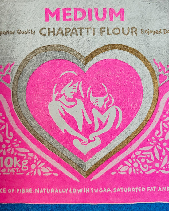 Close up of a colourful print showing a bright pink bag of "Elephant Atta", which is a type of flour used for making chapati.