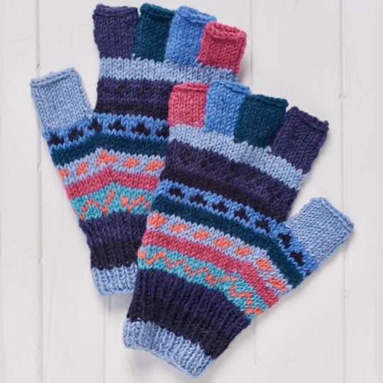 Pair of colorful knitted fingerless gloves on a white wooden surface