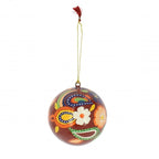 Red bauble with floral and paisley design. Gold string with red tassel. White background.