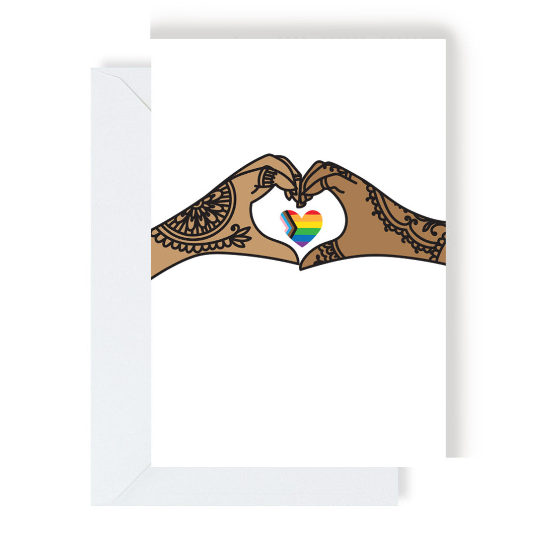 A greeting card featuring two hands adorned with henna, forming a heart shape around a rainbow heart.