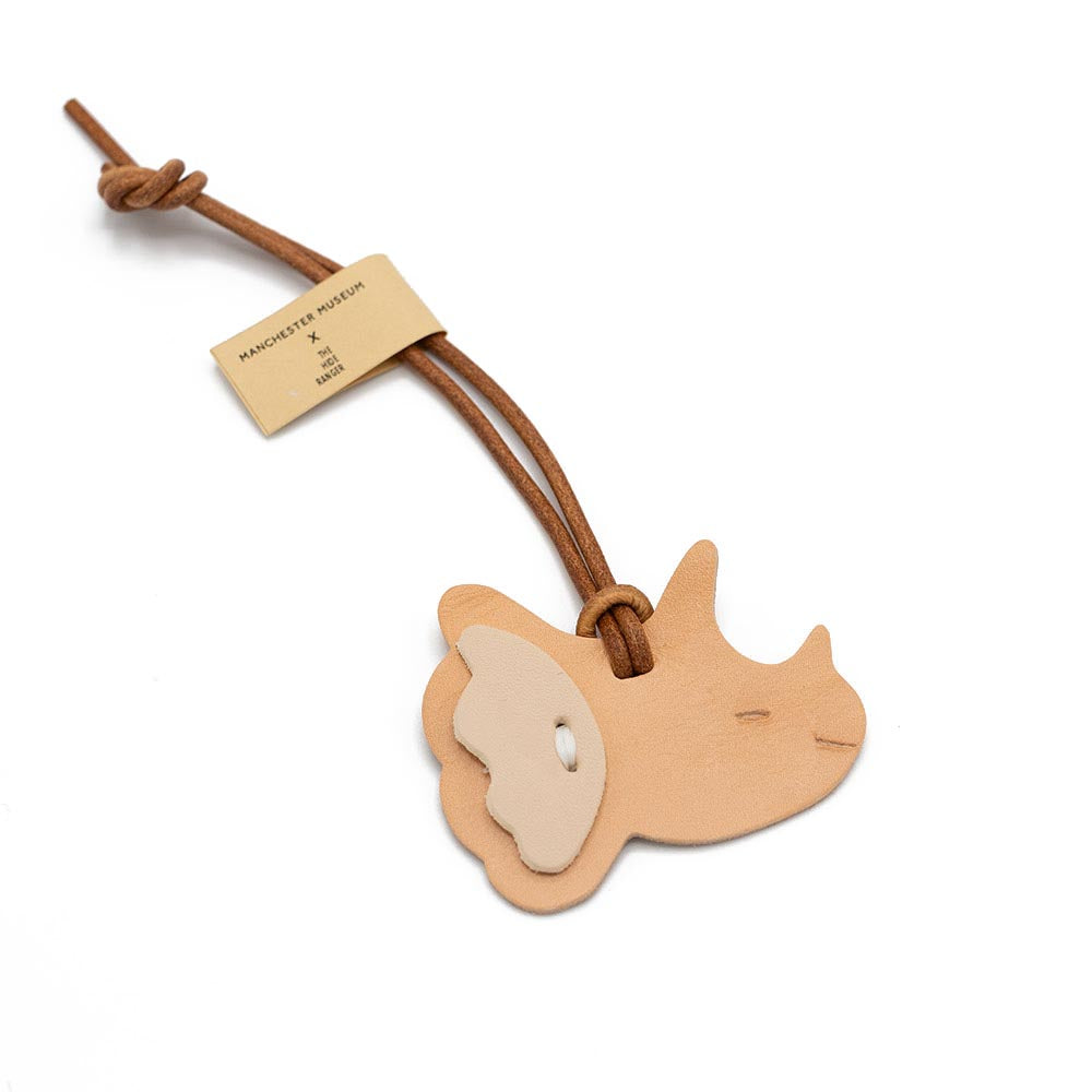 Wooden dinosaur-shaped key charm with a leather strap on a white background
