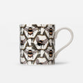 A white ceramic mug featuring an all-over pattern of detailed bumblebees in a honeycomb pattern, with a clean white handle, set against a light gray background.