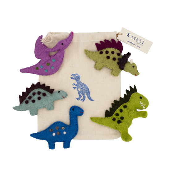 Load image into Gallery viewer, Five felt dinosaur finger puppets lying on the cotton bag they come in.
