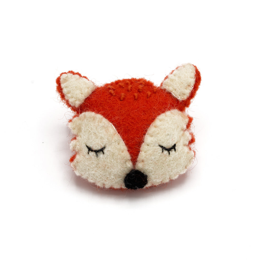Felted orange-red fox head with white cheeks and closed eyes.