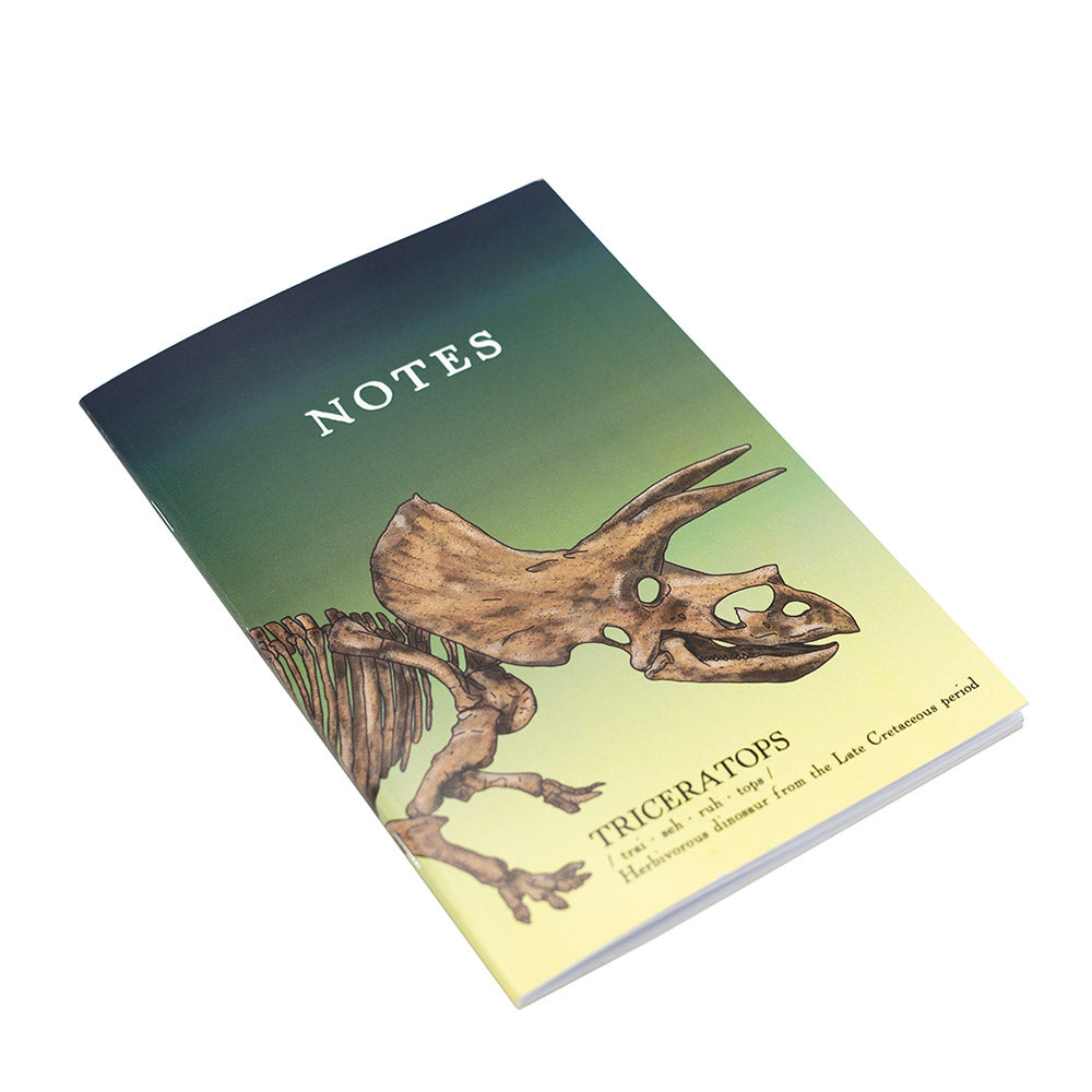 Notebook with triceratops skeleton illustration on a gradient cover