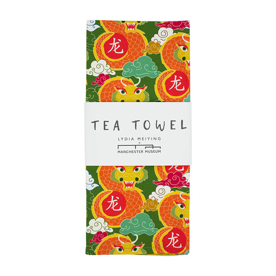 Tea towel with green, orange, red and yellow dragon repeat pattern. White belly band with Lydia Meiying branding