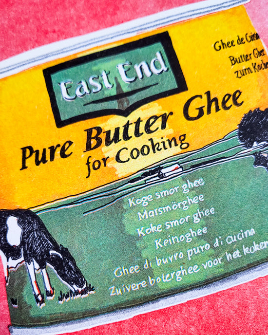 Close up of a colourful print showing a yellow and green tin of "East End Pure Butter Ghee", which is a type of butter used in cooking.