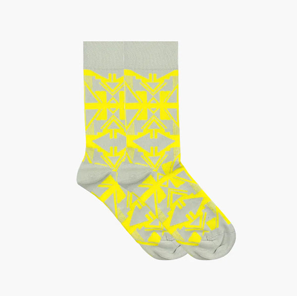 Socks with white and beige geometric pattern photographed against a white background.
