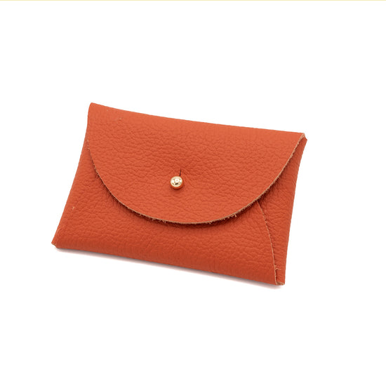 Orange rectangular leather purse with a gold button