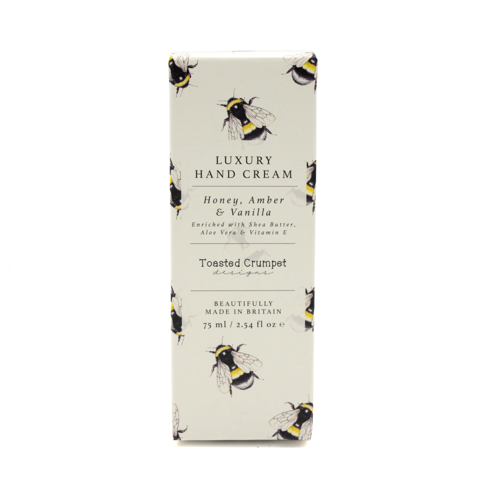 Rectangular box packaging of hand cream photographed against white background. Bee patterned design on package.