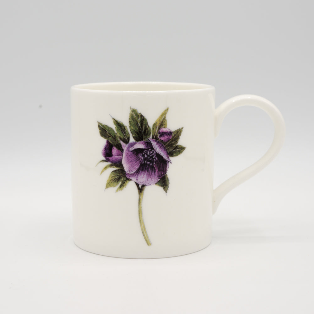 Load image into Gallery viewer, White mug with an illustration of a hellebore flower on it. Photographed against a white background.
