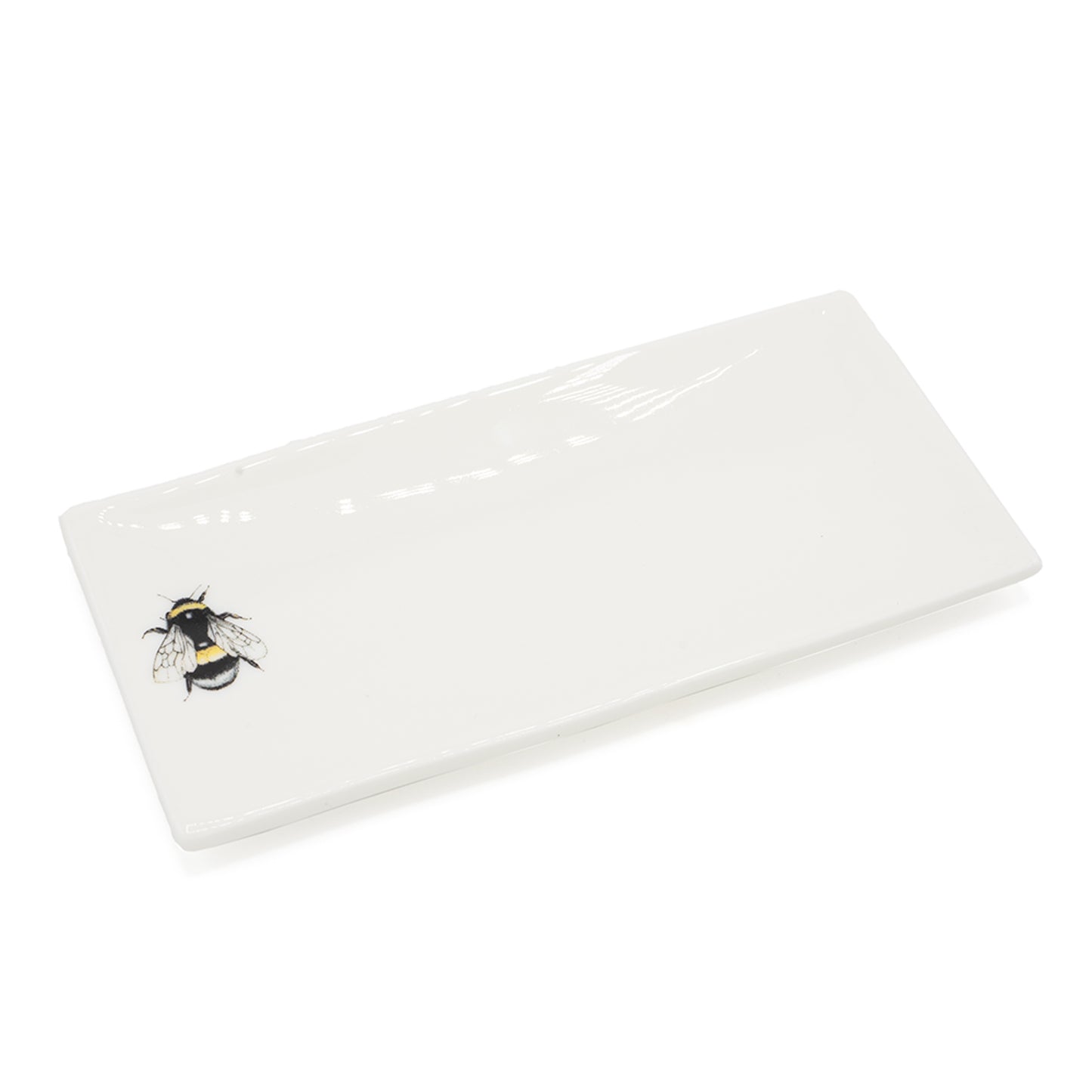 Rectangular soap dish with a picture of a bee on it. Photographed against white background.