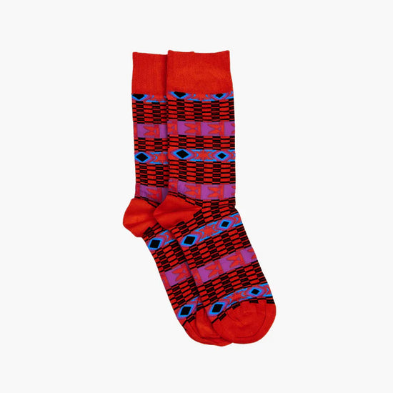 Red, blue and purple socks in a Bamana inrpired pattern - white background.