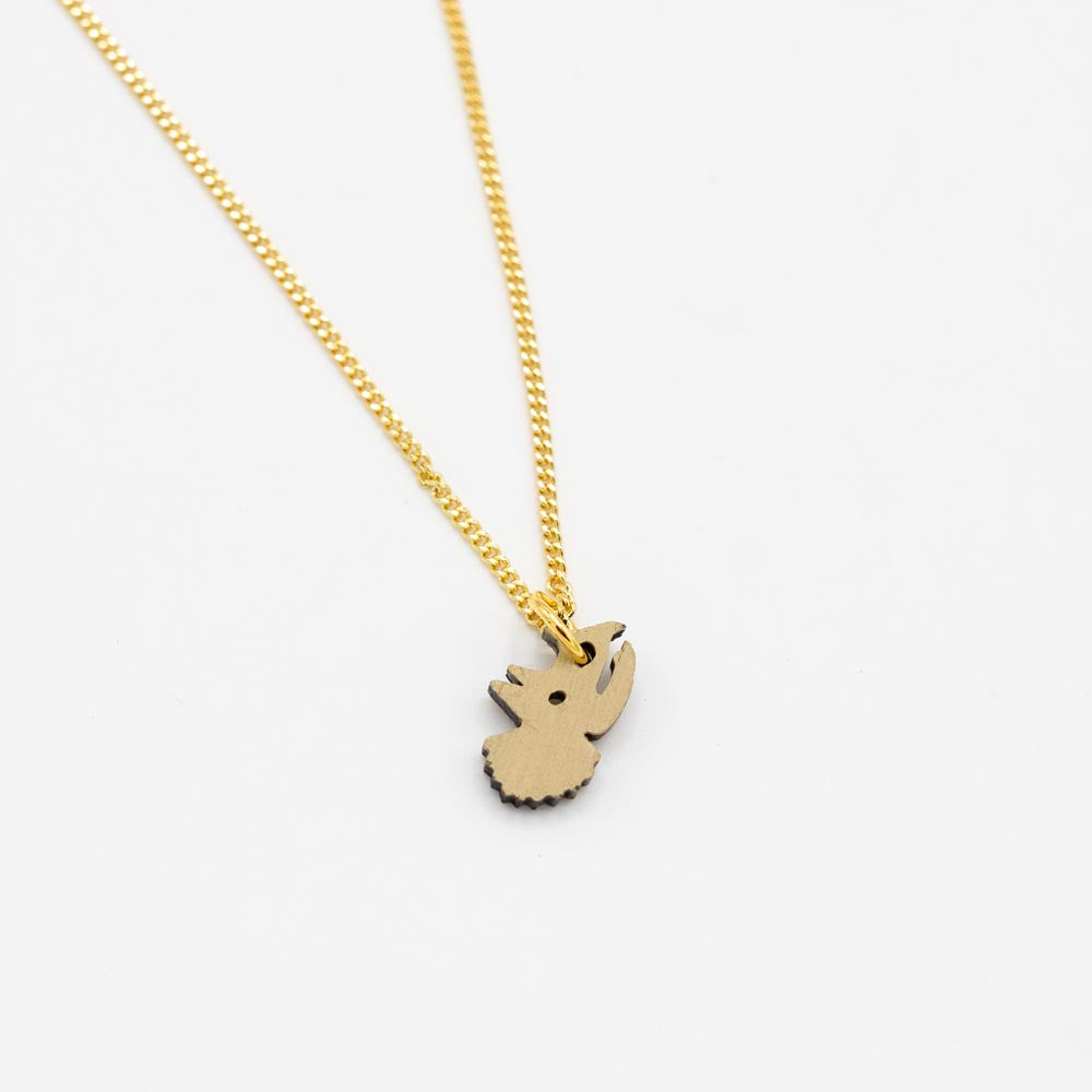 Gold chain necklace with a green triceratops head-shaped pendant on a white background