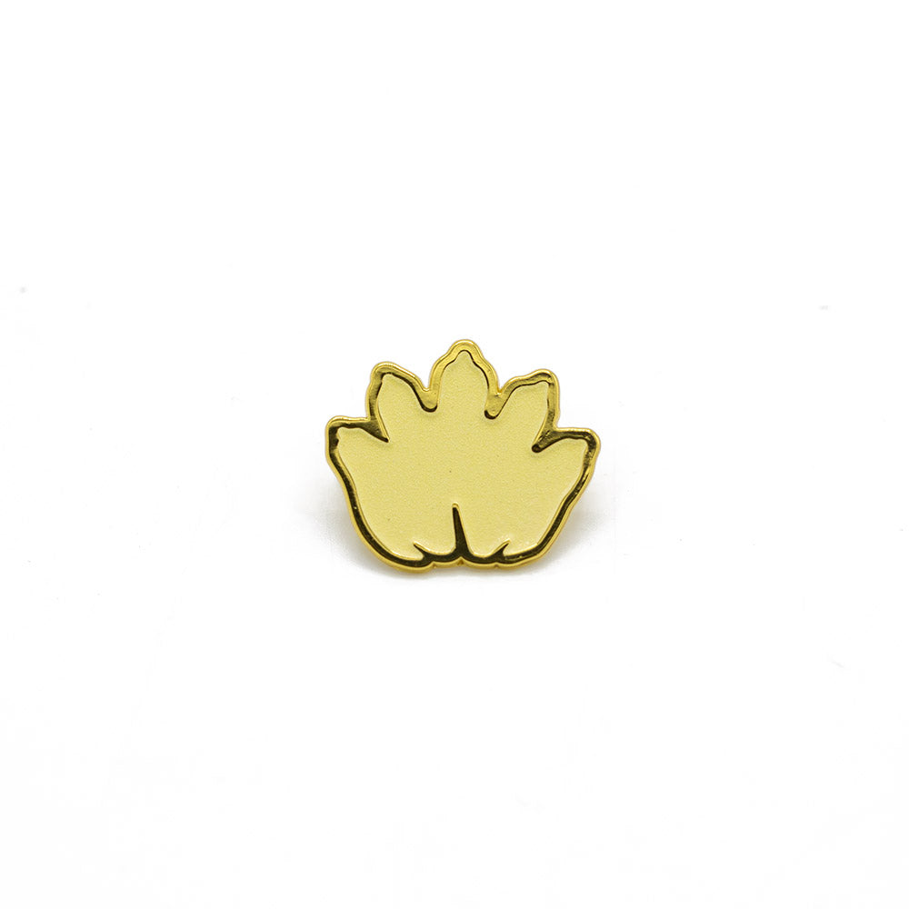 Gold-colored leaf-shaped pin on a white background